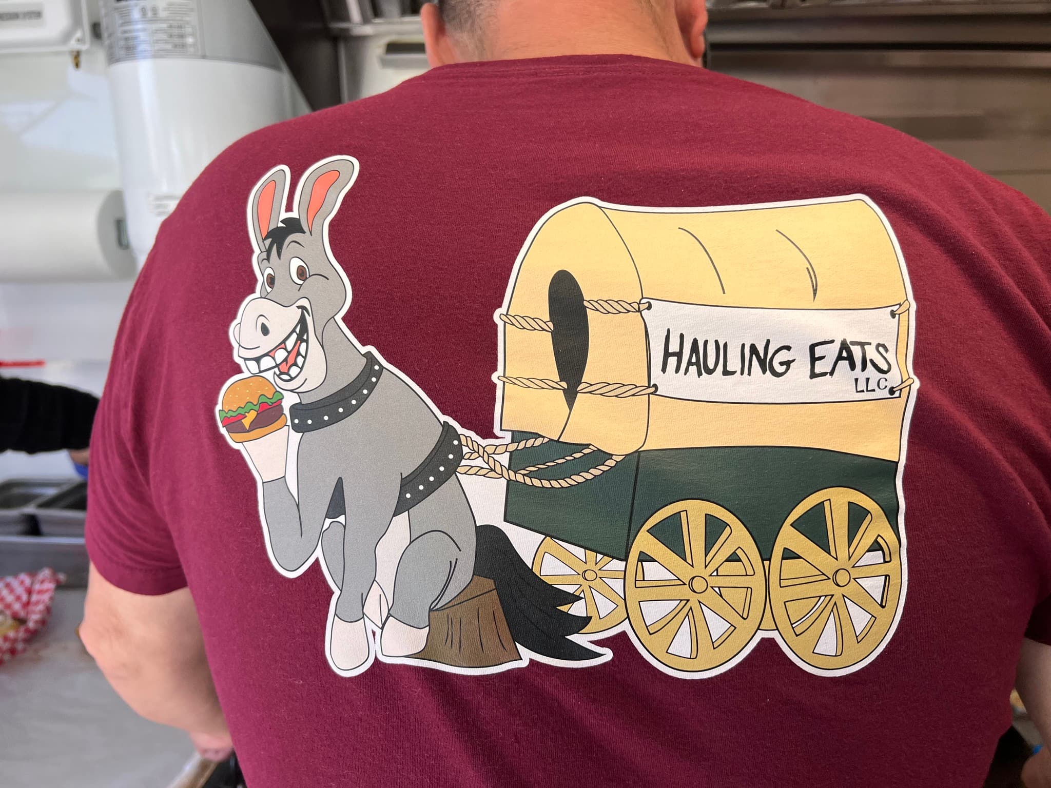 Hauling Eats mule and wagon logo printed on a t-shirt