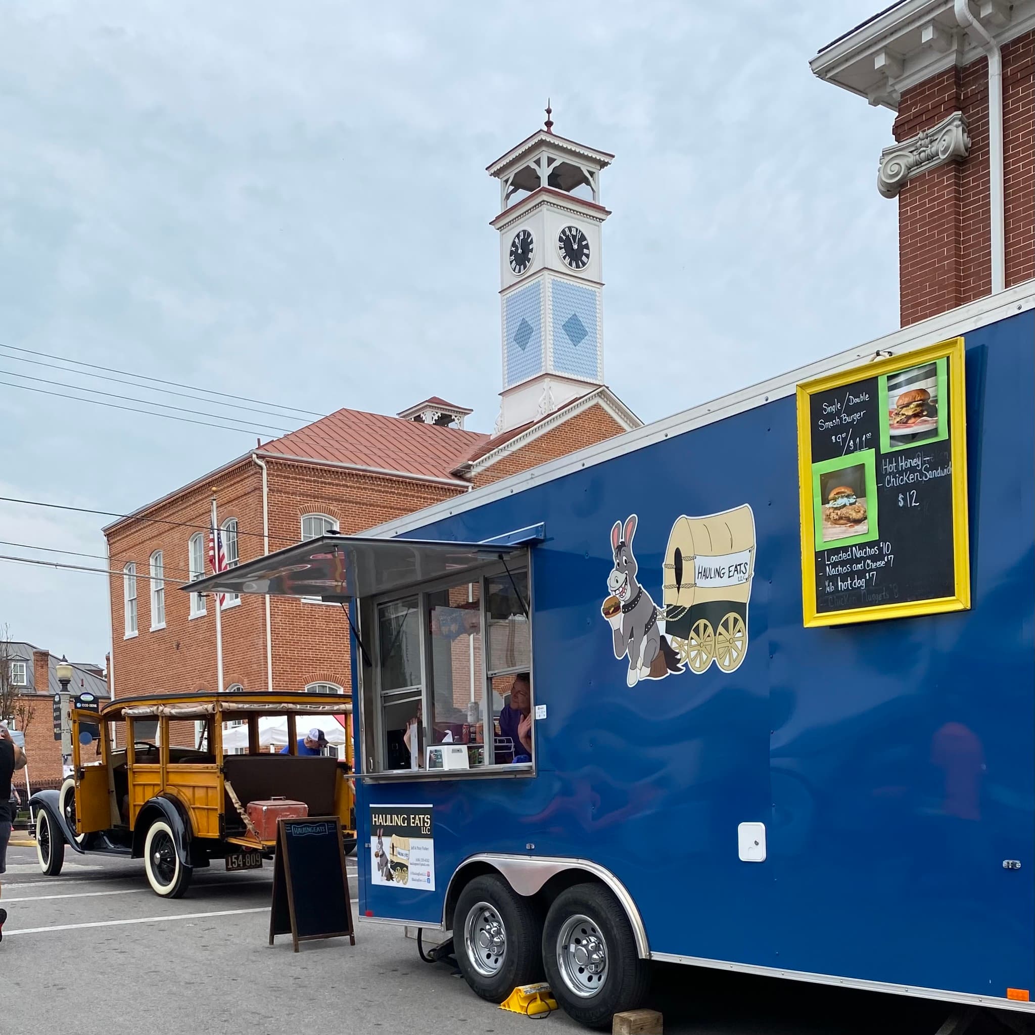 Hauling Eats trailer parked downtown next to a clock tower